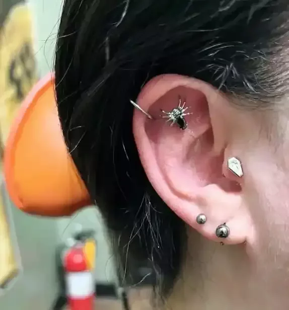 Fresh helix flat done using a titanium internally threaded spider with black cubic zirconia and internally threaded labret post done by Amber Paje of James River Tattoo in Carrollton Virginia