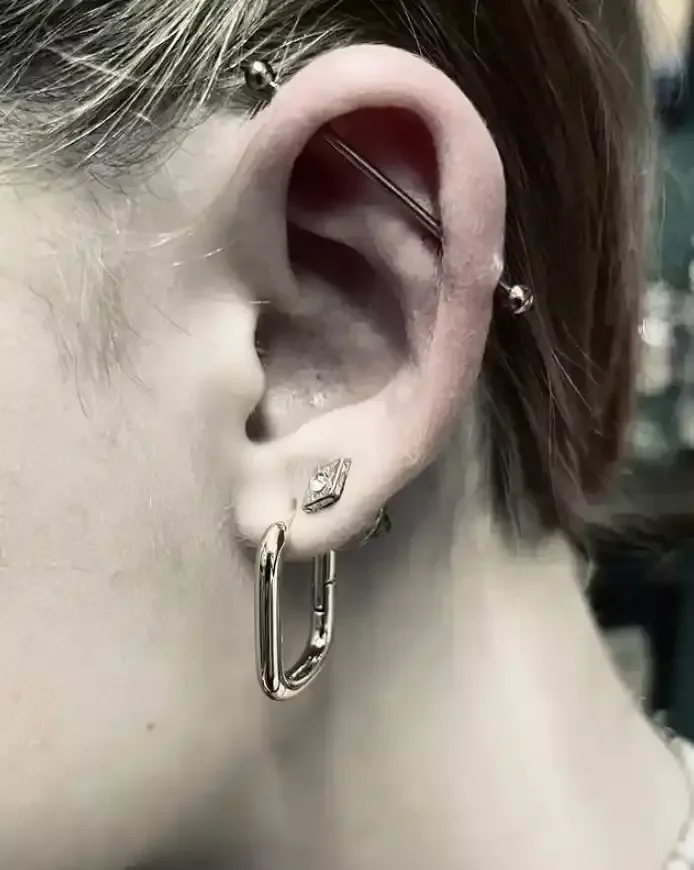 Fresh industrial piercing with a titanium straight barbell done by Amber Paje of James River Tattoo in Carrollton Virginia