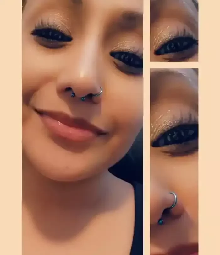 Fresh septum piercing using a titanium circular barbell and a healed nose piercing with a titanium clicker with both anodized to a teal color by Amber Paje of James River Tattoo in Carrollton Virginia