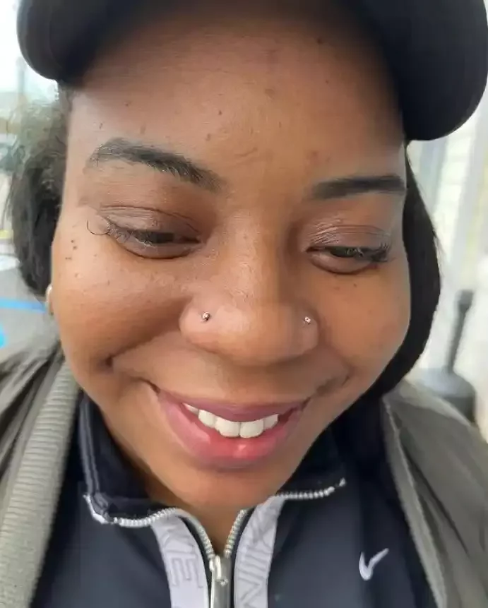Healed paired nostril piercings featuring titanium threadless cubic zirconia ends and threadless labret posts done by Amber Paje of James River Tattoo in Carrollton Virginia