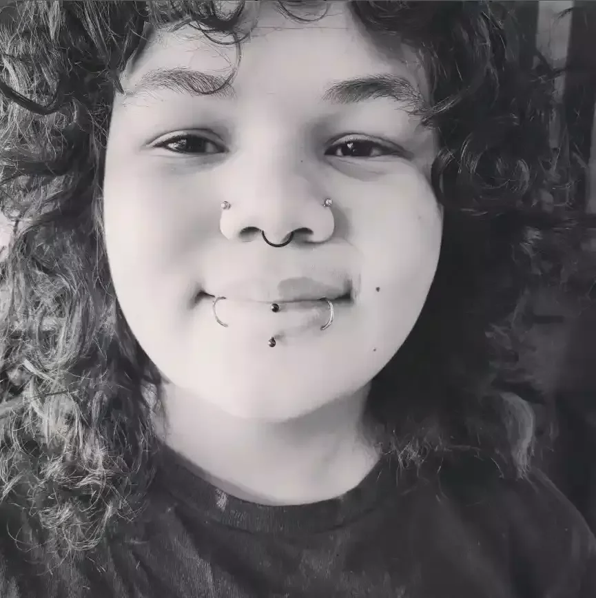 Face titanium clickers in paired labrets in vertical labret PVD clicker septum piercing and ball ends with threadless labret posts in a double nostril by Amber Paje of James River Tattoo Carrollton VA