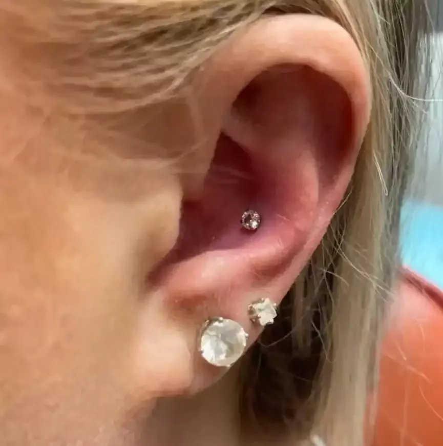 Fresh conch piercing using threadless cubic zirconia end on a threadless labret post done by Amber Paje of James River Tattoo in Carrollton Virginia