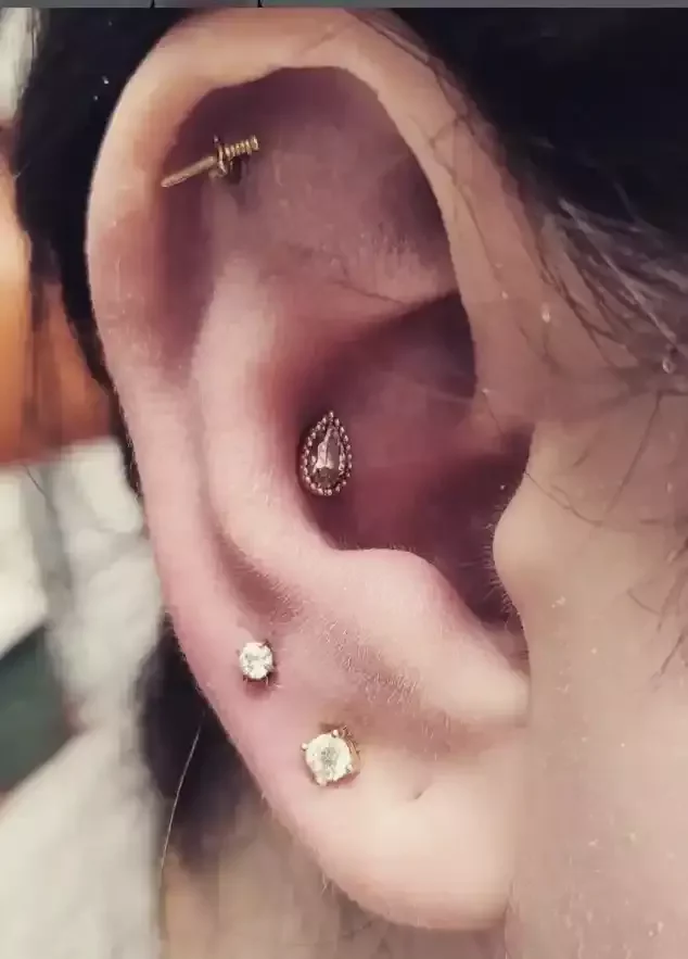 Gold PVD CZ earlobe ends pear conch dagger flat helix on titanium threadless labret posts done by Amber Paje of James River Tattoo Carrollton VA