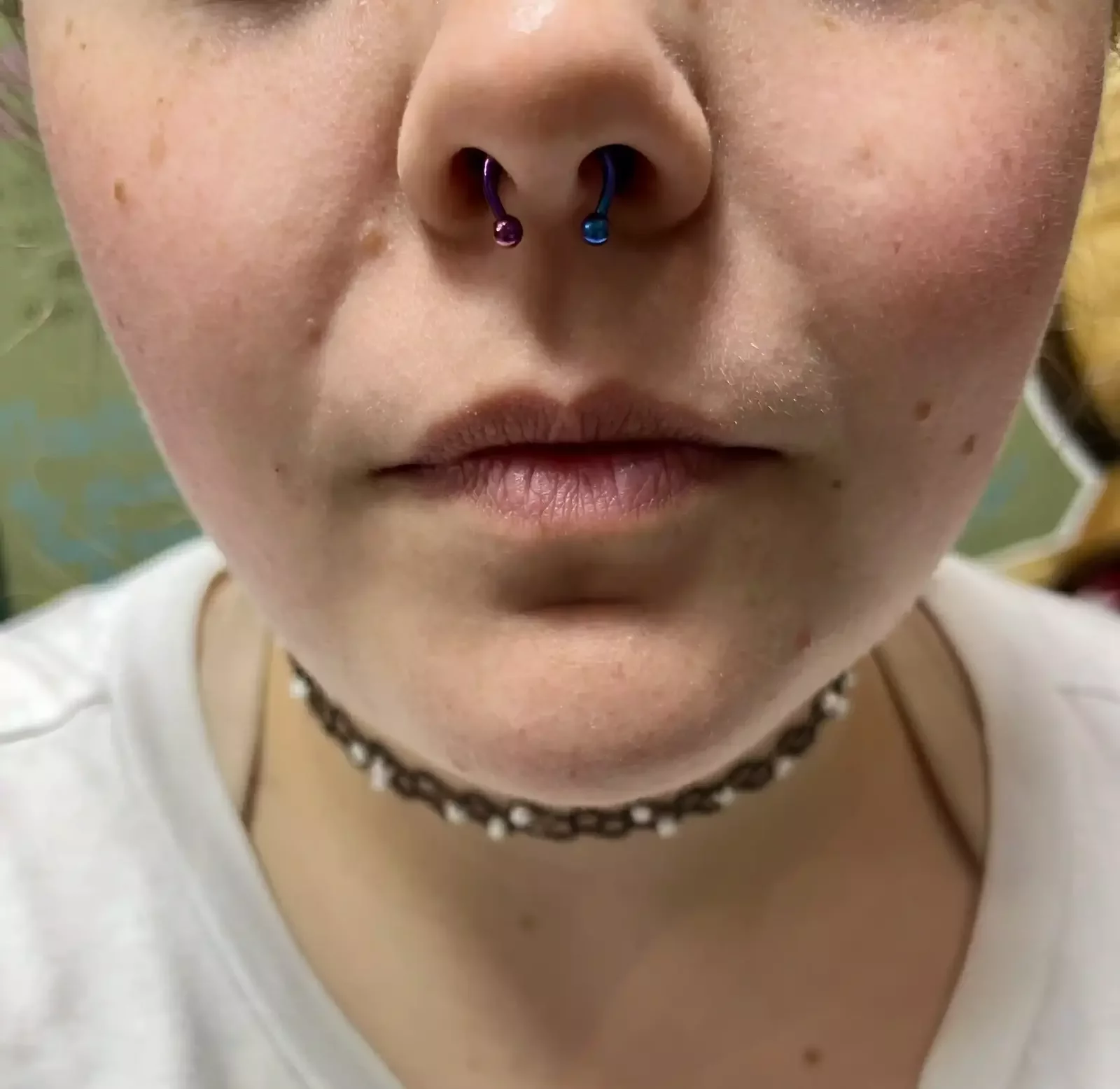 New septum piercing completed with a titanium circular barbell that was anodized pink on the right side and blue on the left side done by Amber Paje of James River Tattoo in Carrollton VA