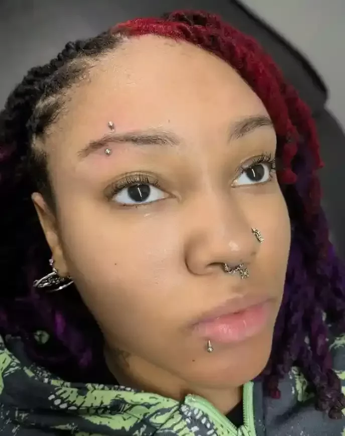Fresh eyebrow piercing done using a titanium curved barbell pierced by Amber Paje of James River Tattoo in Carrollton Virginia